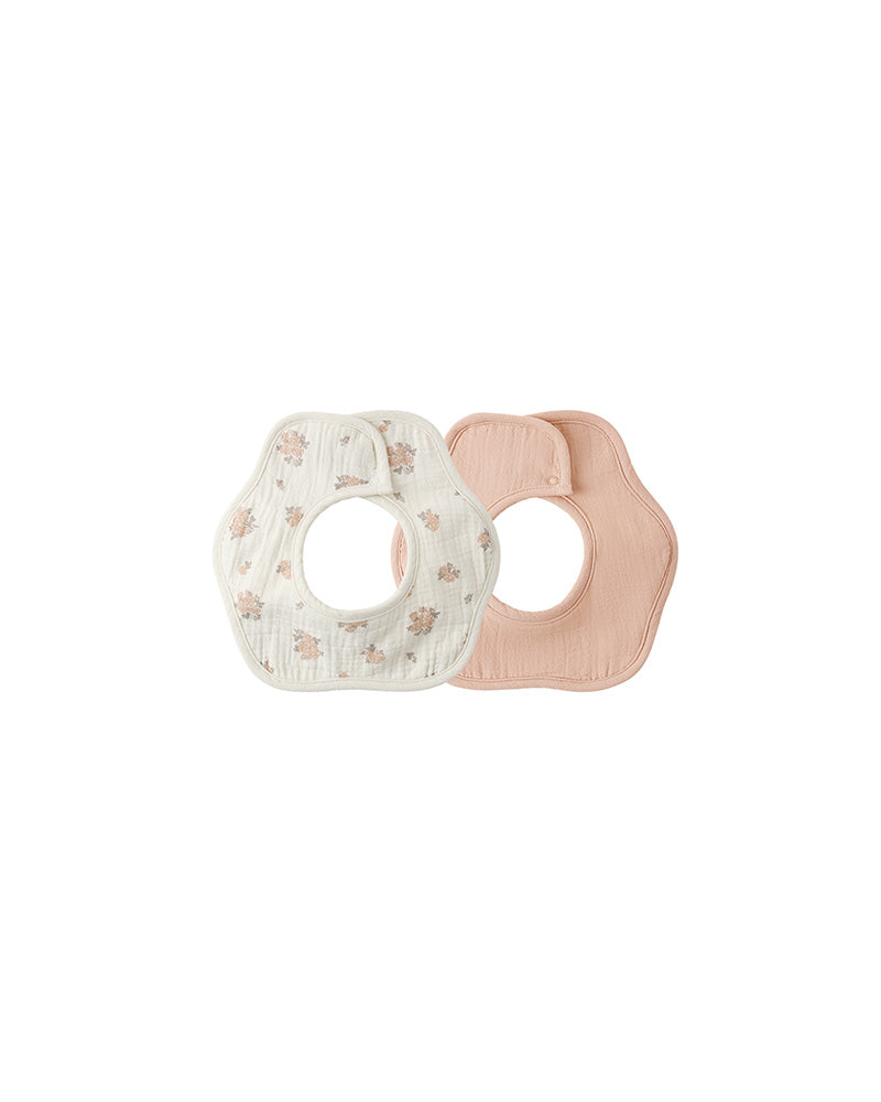 Two baby bibs, one with floral pattern and one solid pink, on a white background.