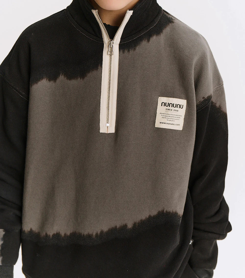 Gray and black pullover with a visible brand label on a white background