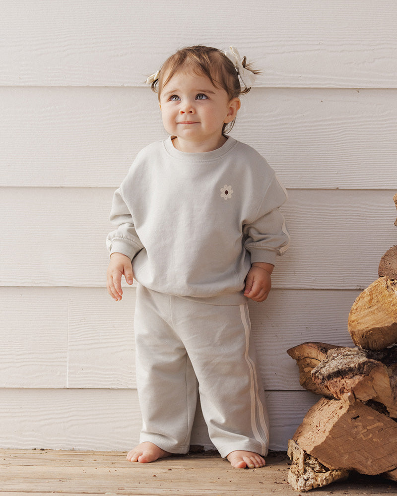 Light sage green wide leg pants with a white stripe down the sides