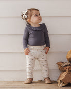 Dark gray ribbed baby bodysuit with ruffled collar on a white background