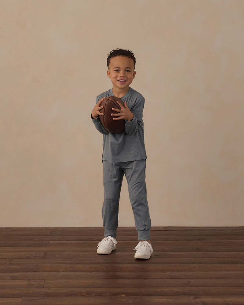 Gray cuffed joggers with a white drawstring and pockets on a white background
