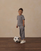 Gray cuffed joggers with a white drawstring and pockets on a white background