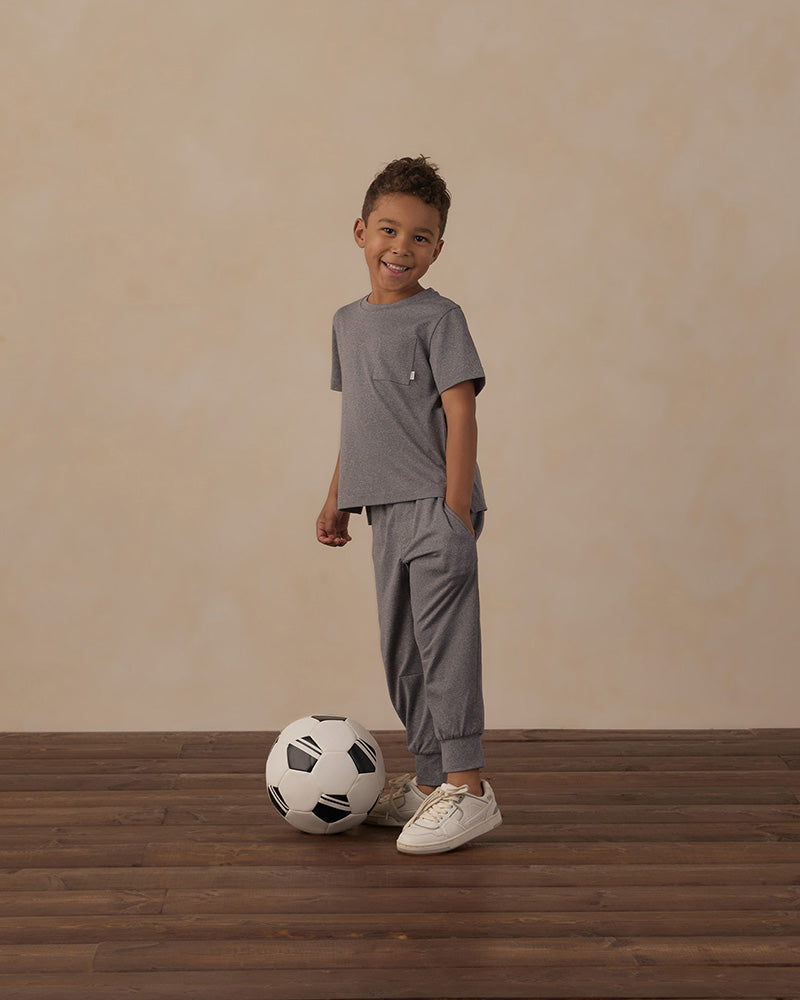 Gray cuffed joggers with a white drawstring and pockets on a white background