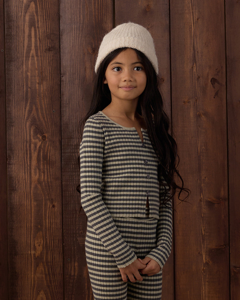 Black and white striped cardigan with a split top and bottom, and buttons on a white background