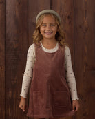 Brown corduroy pinafore dress with buttons and front pockets 