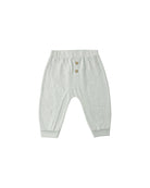 Light blue/green baby pants with button details on a white background