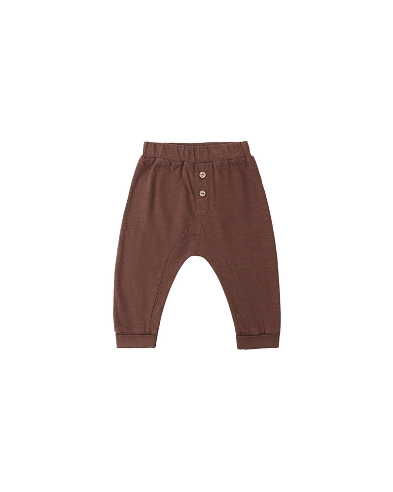 Brown baby pants with button details on a white background