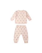 Pink children's pajama set with a candy-cane pattern on a white background