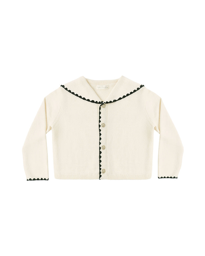 White cardigan with black trim and a fold-over collar on a white background
