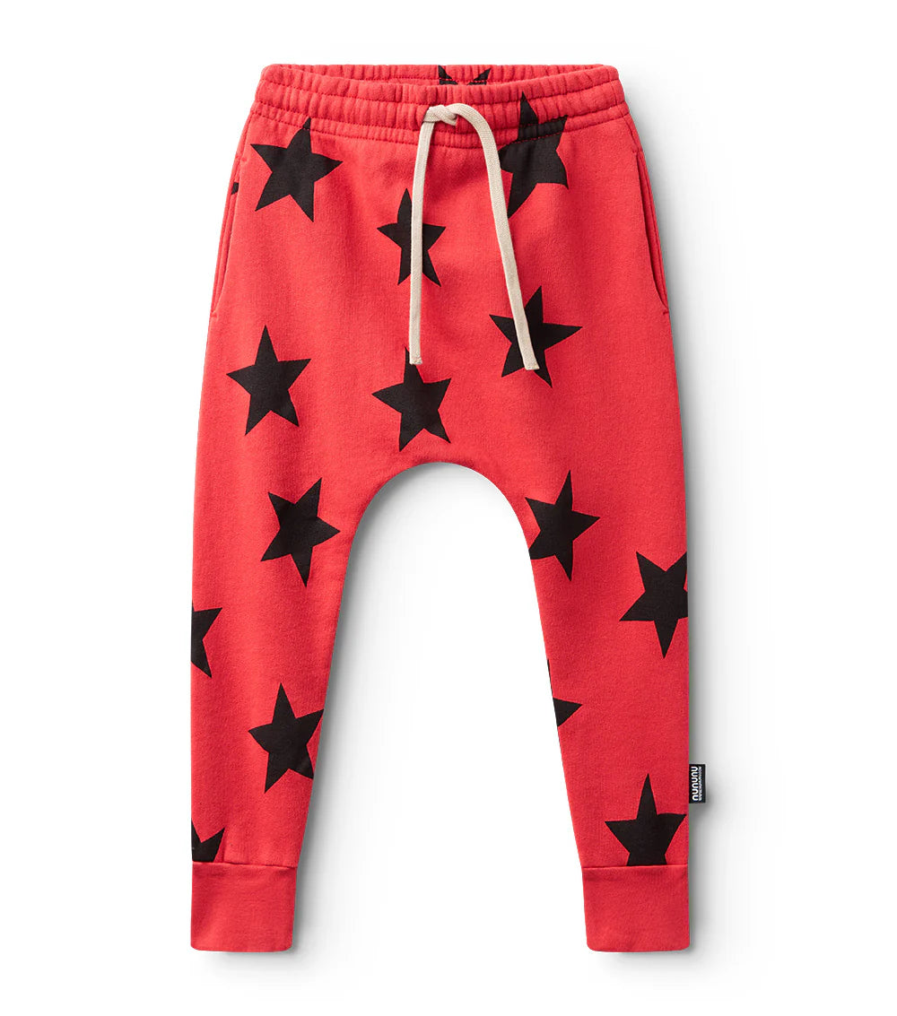 Red children's pants with black star patterns on a white background