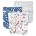 A set of three burp cloths with different patterns. One has a navy blue pattern with stars and moons, another with a beige animal pattern, and the last with a grey paw pattern.