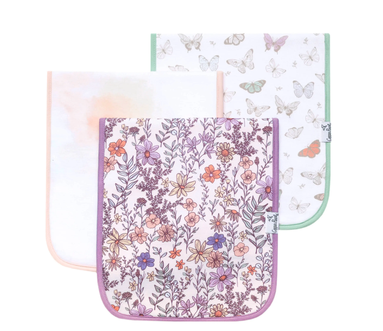 A set of three burp cloths with floral and butterfly patterns in shades of pink, purple, and green.