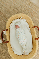 sleeping baby in swaddle and infant hat