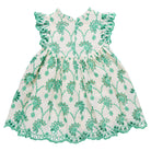 Green and white floral dress with ruffled details on a white background