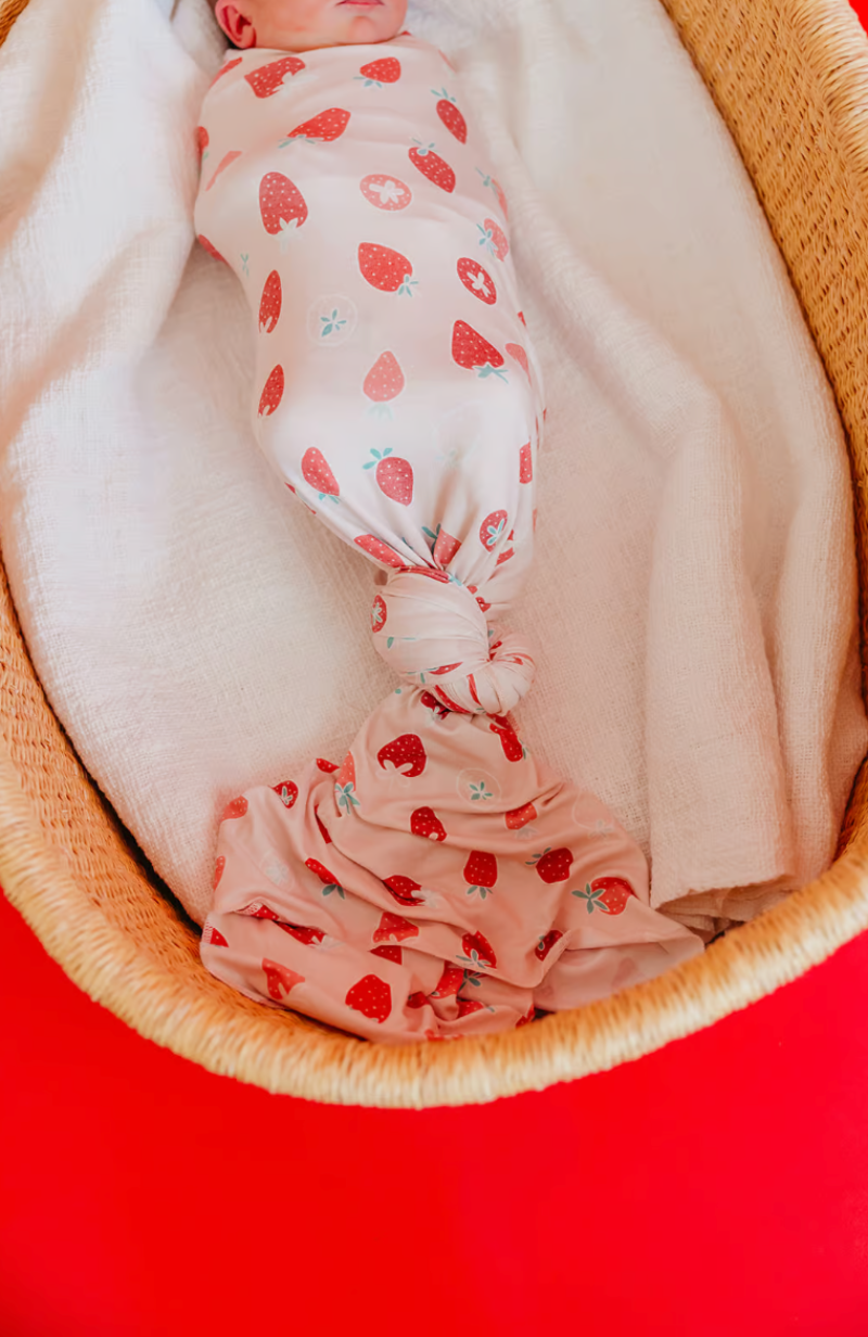 baby strawberry swaddle with knot at bottom 