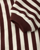 Close-up of burgundy and white striped baby romper 