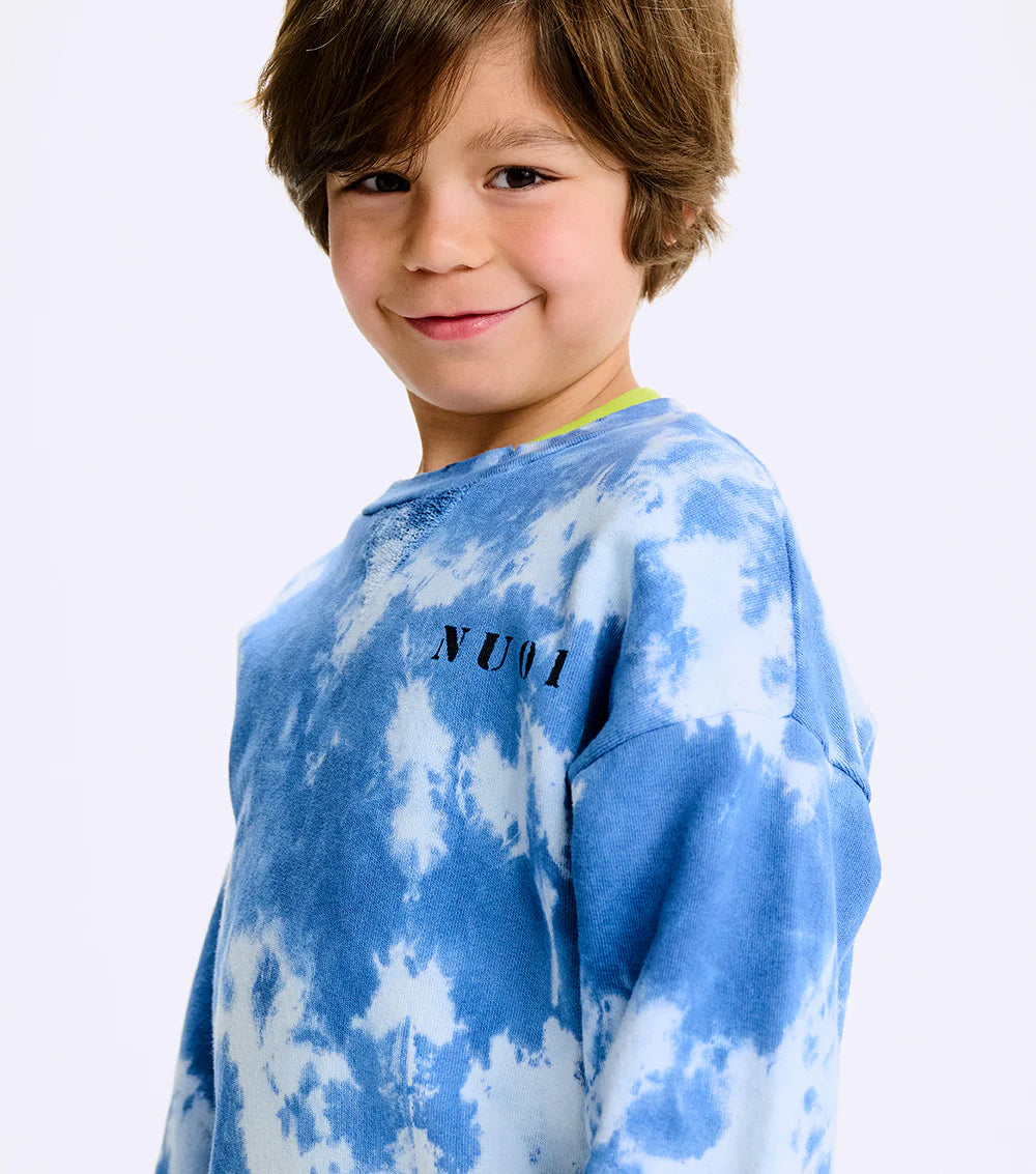child wearing a blue and white tie-die shirt