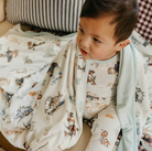 toddler with a cowboy print blanket