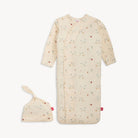 Baby sleep bag with floral pattern and matching hat on a white background
