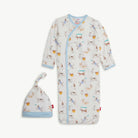 Baby gown with dog sports pattern and matching hat on a white background