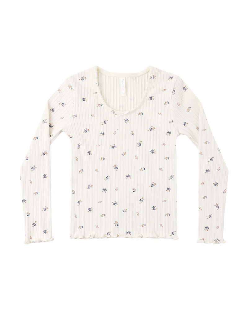 White ribbed long-sleeve shirt with subtle floral pattern and lettuce trim on a white background