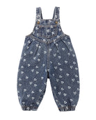 Blue denim overalls with floral pattern and front pocket on a white background