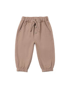Brown children's pants with pockets, buttons, and an elastic waistband on a white background.