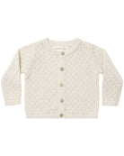 An off-white knit cardigan sweater for toddlers, featuring a textured open-knit pattern and four brown buttons down the front, displayed flat against a white background.