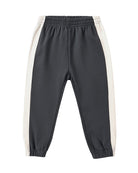 Black cuffed jogger pants with white side stripes on a white background