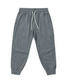 Gray cuffed joggers with a white drawstring and pockets on a white background