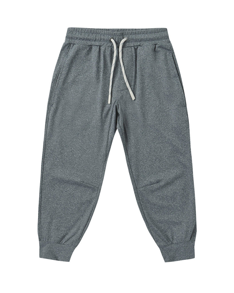 Gray cuffed joggers with a white drawstring and pockets on a white background