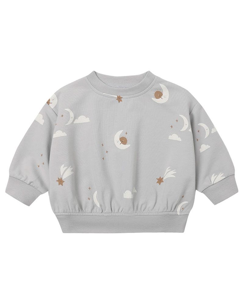 A light gray long-sleeve sweatshirt for toddlers, featuring an all-over celestial print of white clouds, crescent moons, and brown stars.