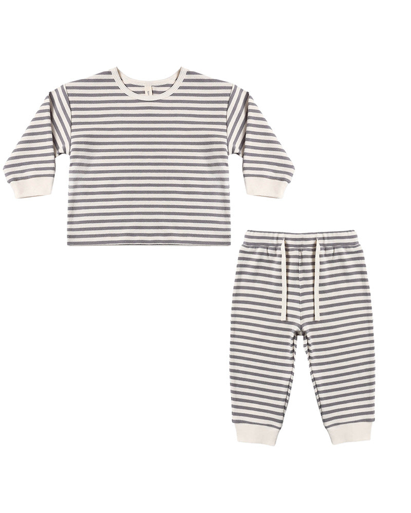 A two-piece children's outfit set featuring a long-sleeve top and matching pants, both with horizontal gray and off-white stripes, laid flat on a white background.