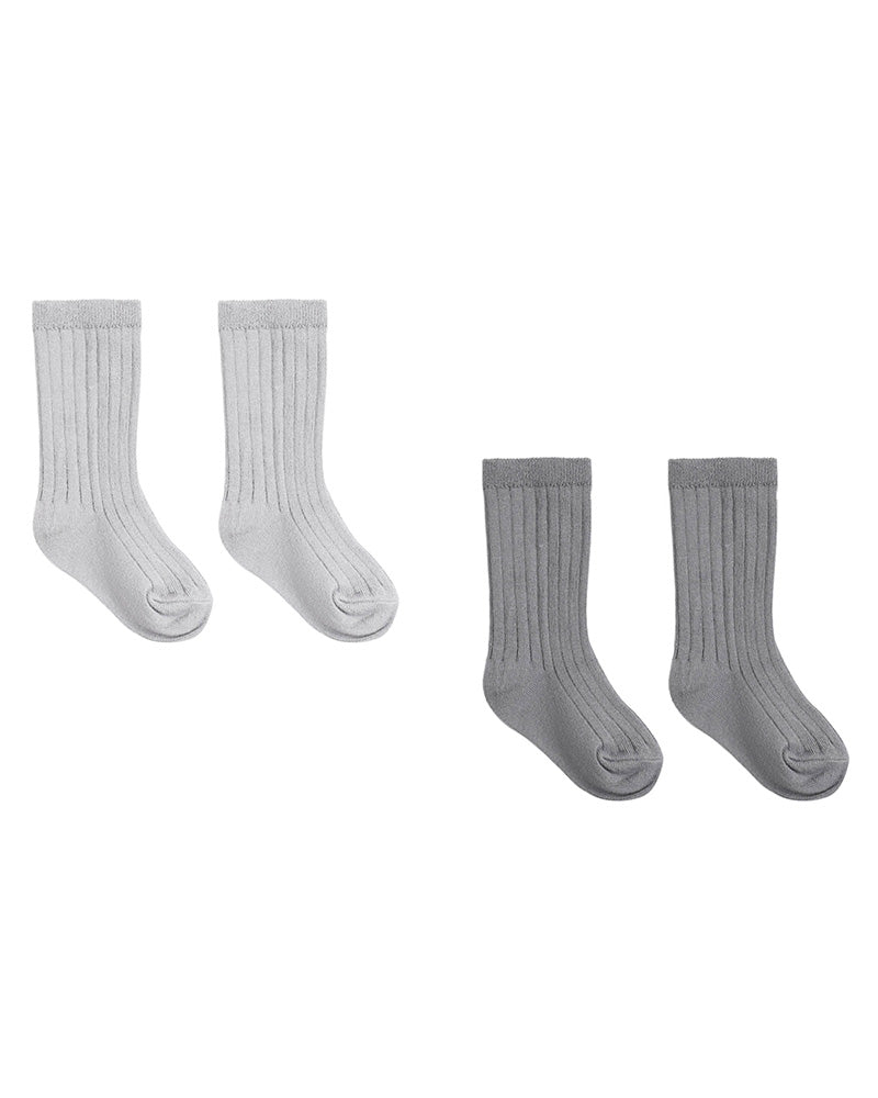 Two pairs of socks, one white and one gray on a white background