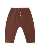 Brown baby pants with button details on a white background
