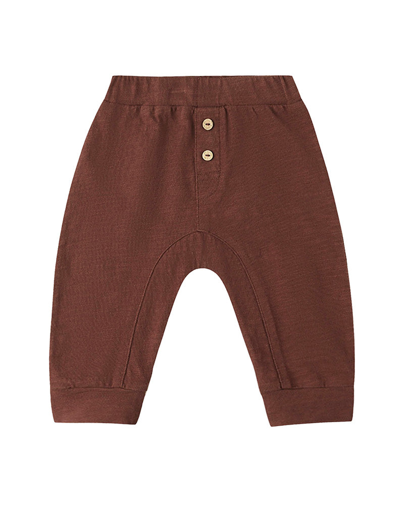 Brown baby pants with button details on a white background