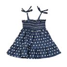 Navy blue dress with white star pattern and bow straps on a white background