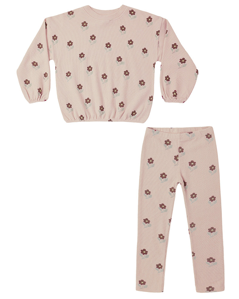 Children's pink outfit with dark pink floral pattern on a white background
