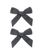 Two gray hair bows on a white background