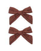 Two mulberry hair bows on a white background