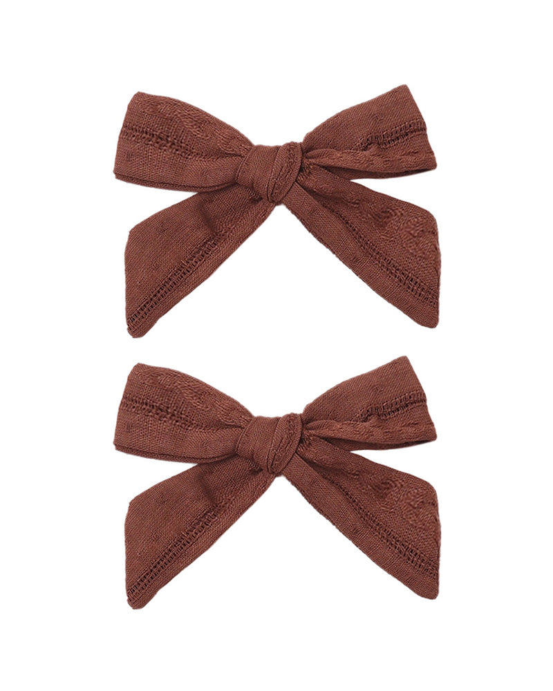 Two mulberry hair bows on a white background