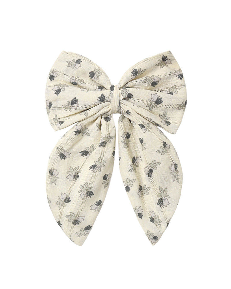 Large bow with floral pattern on a white background