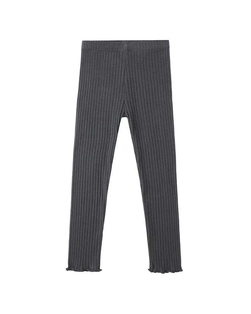 Dark ribbed leggings with ruffle detail on bottom against a white background
