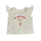 White crop top with red cherry graphic and ruffled sleeves on a white background