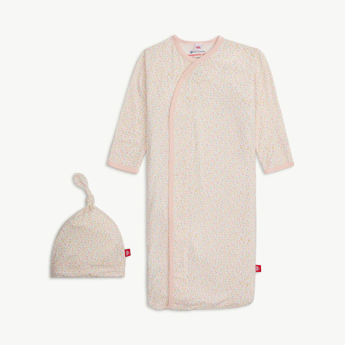 Baby gown and hat set with pink trim and a small floral pattern on a white background