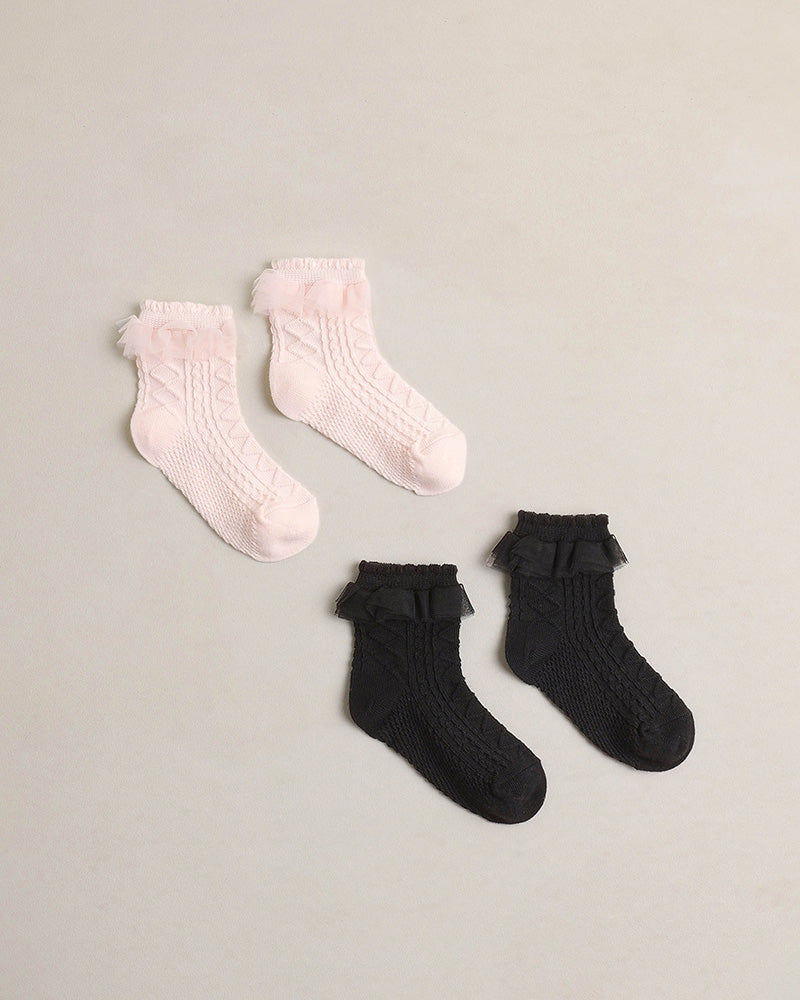Two pairs of socks, one black and one pink with a ruffle tulle detail on the top