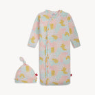 Baby onesie with multi-color floral pattern and matching hat on a white background