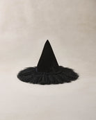Black witch hat with a fluffy tulle base and a sparkly detail on a beige background