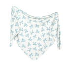 A white knit swaddle blanket with a blue bow pattern, displayed on a flat surface.