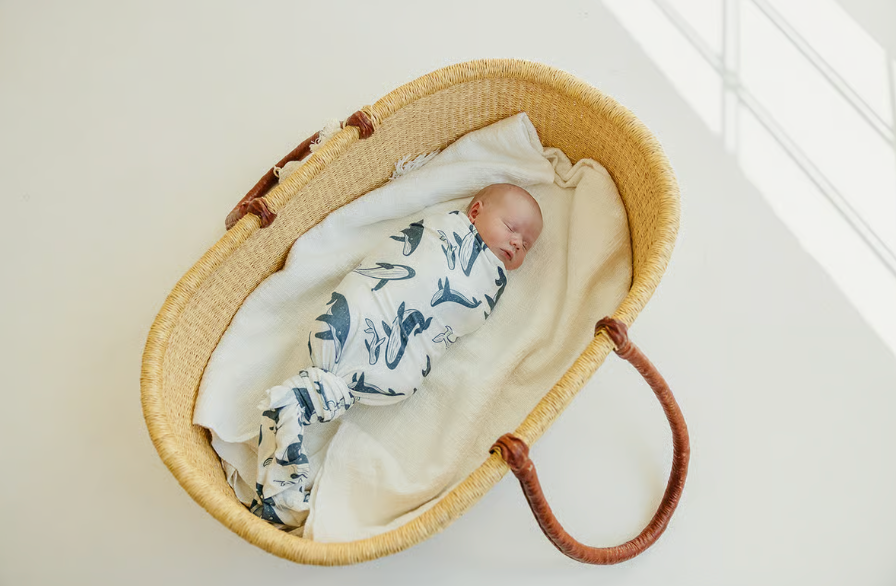 white knotted swaddle blanket with blue whales print 